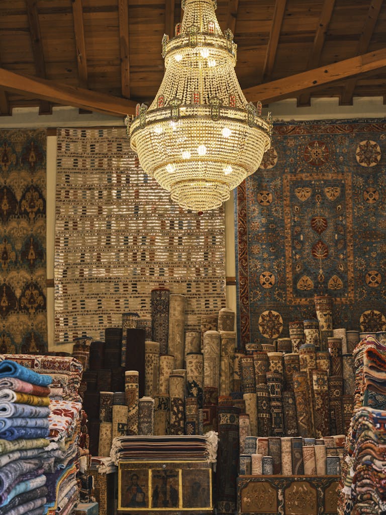 Charming interior of a rug store featuring oriental designs and a dazzling chandelier.